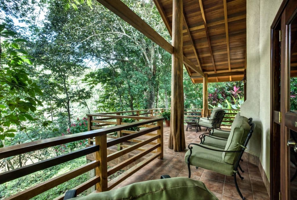 A tranquil balcony overlooking a lush green landscape.